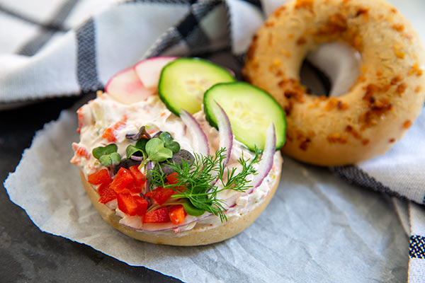 gluten free garden vegetable schmear on onion bagel
